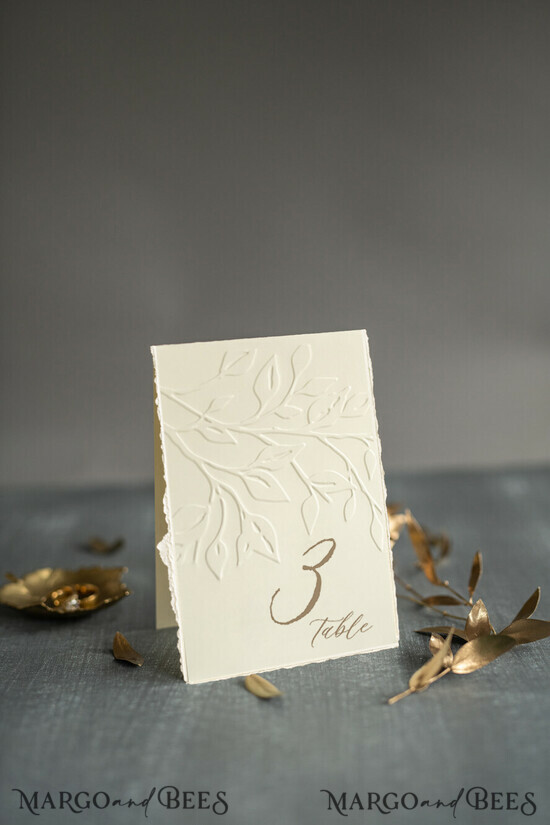 TABLE DECOR SIGNS glitter Elegant Wedding Table Number Card with Embossed Floral Design – Ivory Textured Paper, Folded Tent Style, Classic Font, Luxury Reception Decor 10/DEsuemBO/tn25