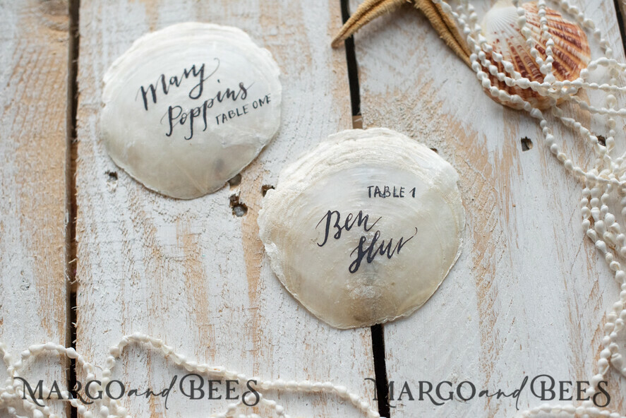 https://margoandbees.com/thumbs/887/templates/template_7/8/images/products/413/9f53d83ec0691550f7d2507d57f4f5a2/place-cards-table-cards-beach-marine-destionation-wedding-theme-2-seacalligraphy-w-1.jpg